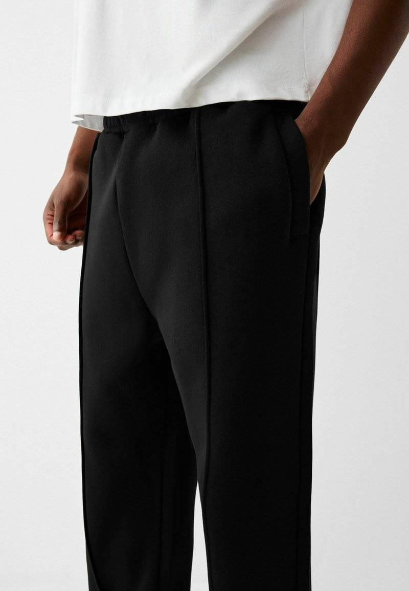Bershka Bershka WIDE - Tracksuit bottoms - black Nur noch ein Tag übrig