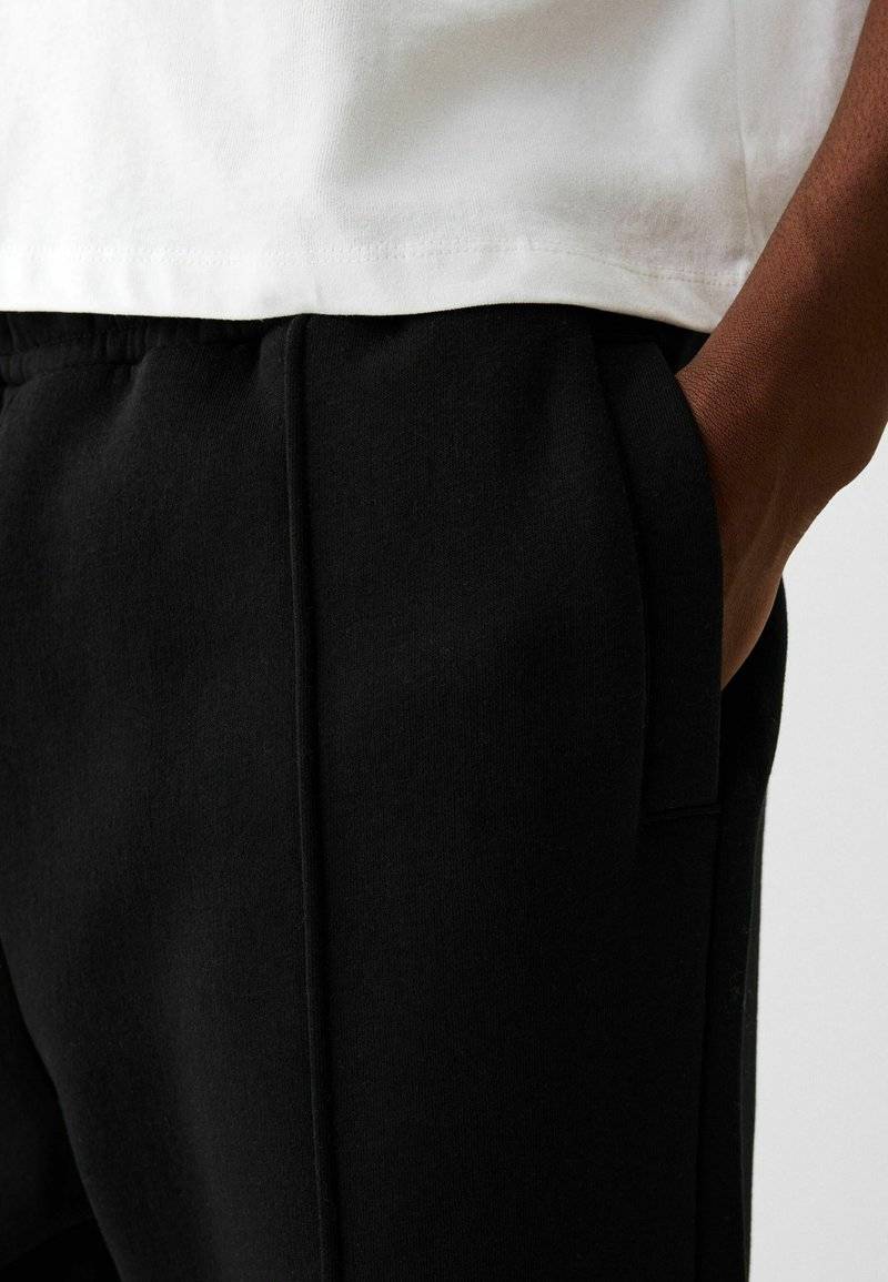 Bershka Bershka WIDE - Tracksuit bottoms - black Nur noch ein Tag übrig