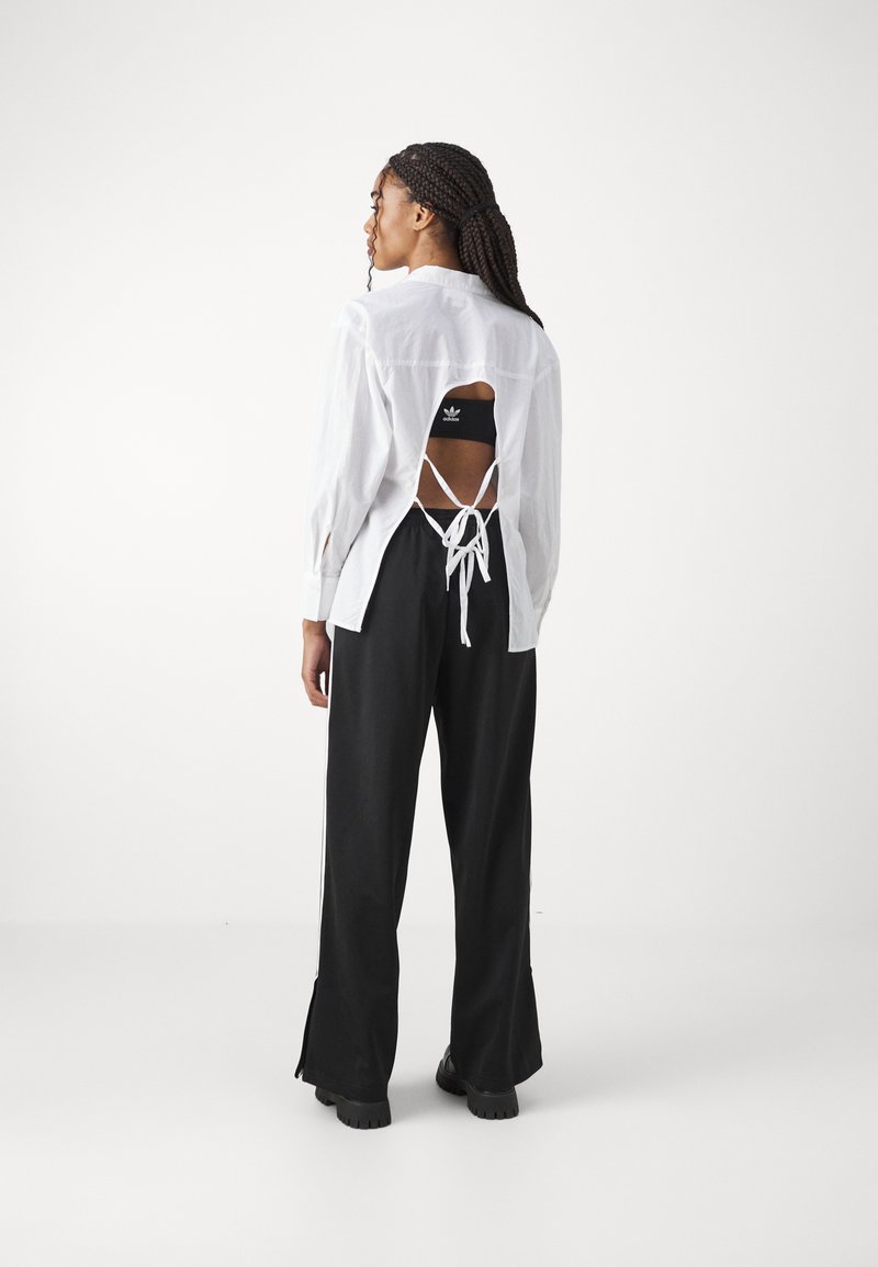 adidas Originals adidas Originals FBIRD LOOSE - Tracksuit bottoms - black Kostenlose Rückgabe