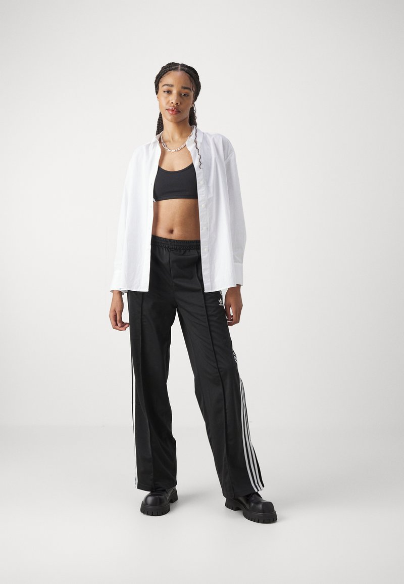 adidas Originals adidas Originals FBIRD LOOSE - Tracksuit bottoms - black Kostenlose Rückgabe