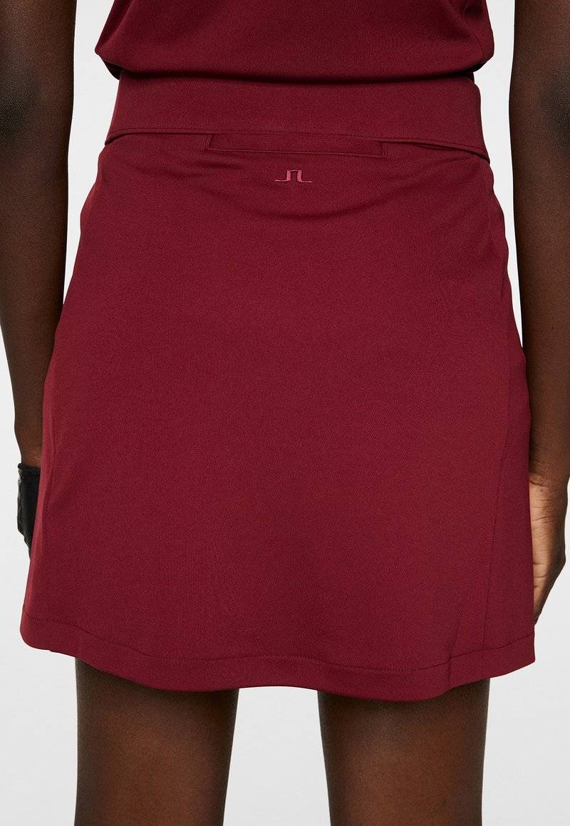 J.LINDEBERG Sports J.LINDEBERG Sports AMELIE MID - Sports skirt - cabernet Rabatt
