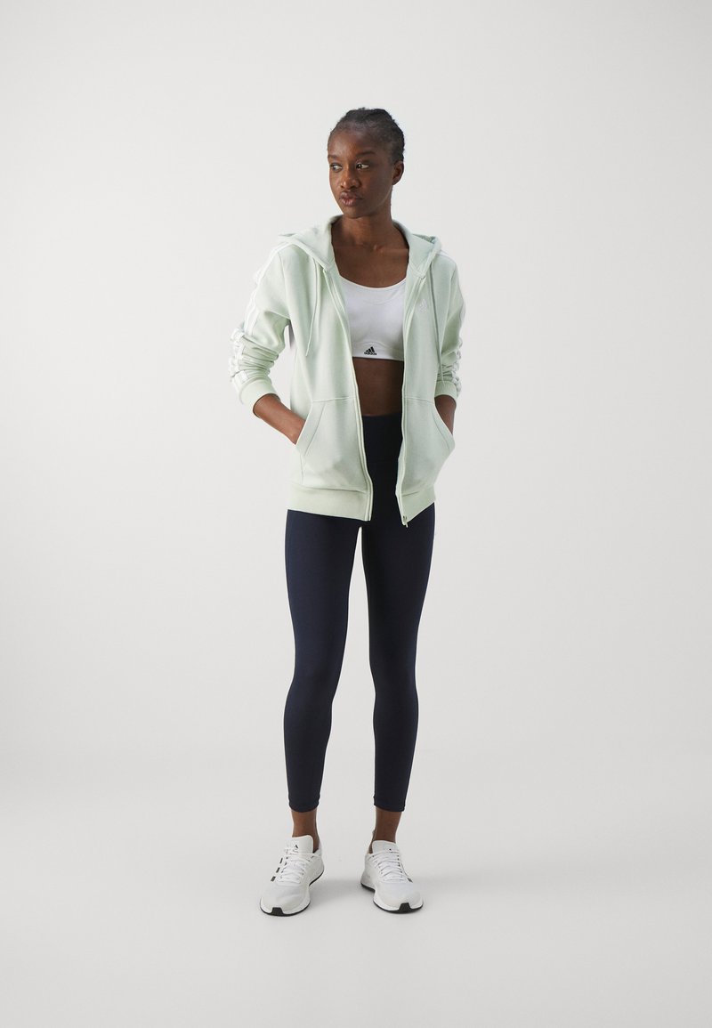 adidas Sportswear adidas Sportswear ESSENTIALS 3 STRIPES FULL ZIP HOODIE - Zip-up sweatshirt - linen green Valentinstagsangebot