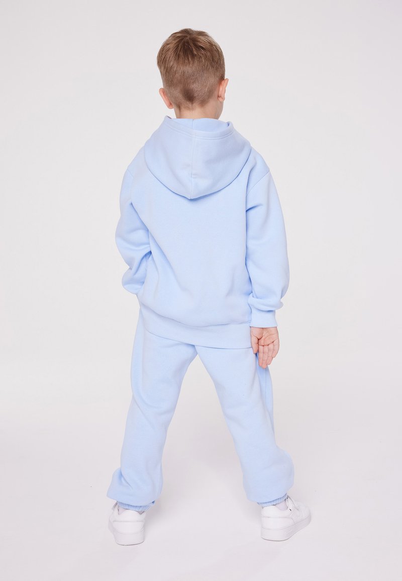 Champion Champion EXCLUSIVE PANT UNISEX - Tracksuit bottoms - light blue Exklusivangebot