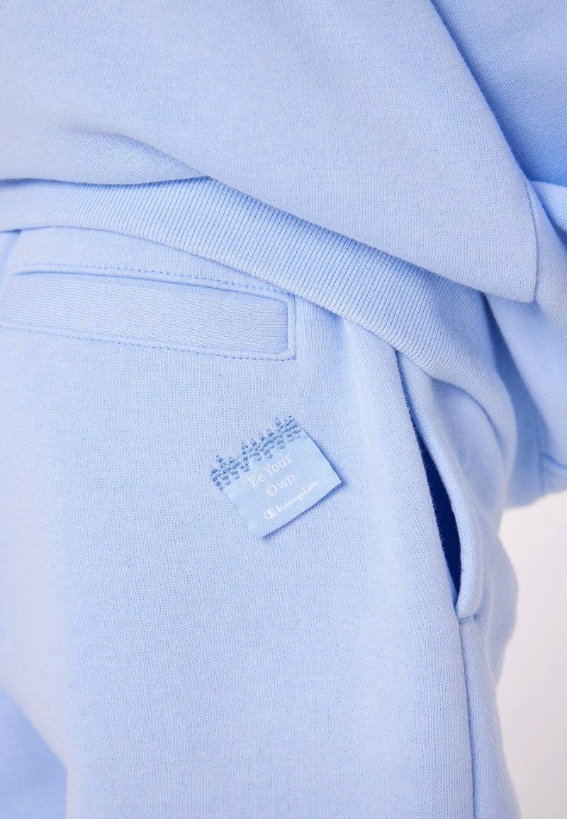 Champion Champion EXCLUSIVE PANT UNISEX - Tracksuit bottoms - light blue Exklusivangebot
