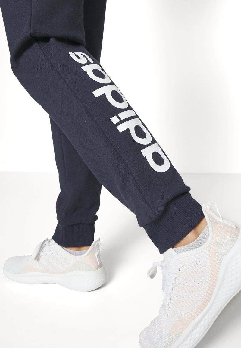 adidas Sportswear adidas Sportswear ESSENTIALS LINEAR CUFFED - Tracksuit bottoms - legend ink Neuheiten